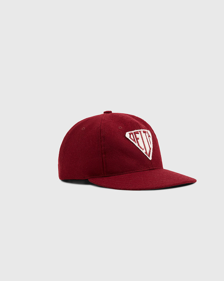 The Mystery Caps of Mexico – Delta Authentic Wool Ballcap by Ebbets Field is a maroon baseball cap with a flat brim and an embroidered white DEFT shield patch, shown on a plain light gray background.