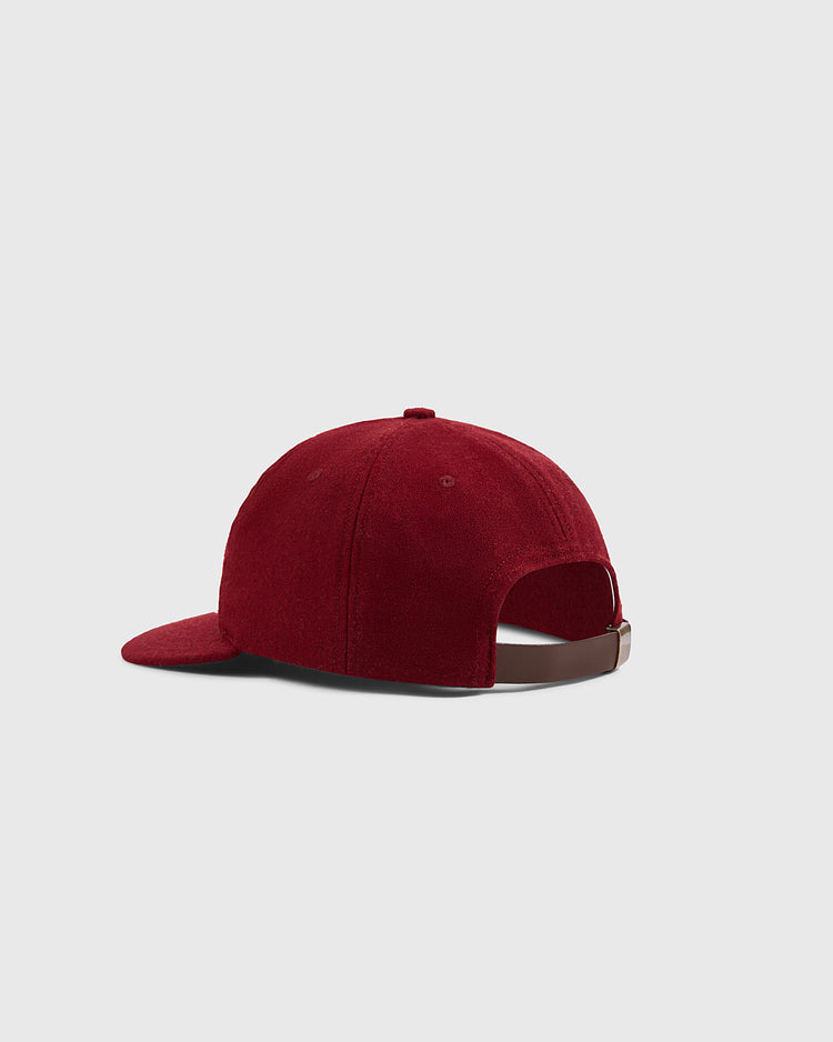 A back view of the Ebbets Field Mystery Caps of Mexico – Delta Authentic Wool Ballcap in red, featuring a brown adjustable strap on a light gray background—a must-have for fans of Mexican baseball history.