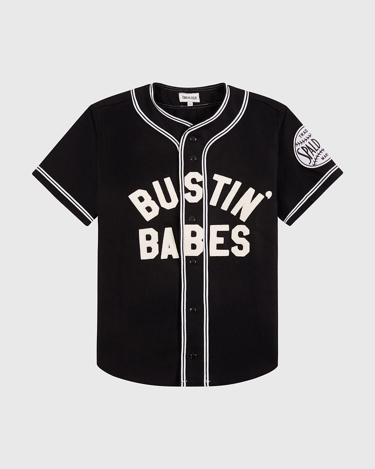 The Ebbets Field Babe Ruth Bustin’ Babes Authentic Wool Baseball Jersey features black wool, white buttons and trim, bold “BUSTIN’ BABES” text on the front, plus a Sand Knit Athletic patch on the left sleeve.