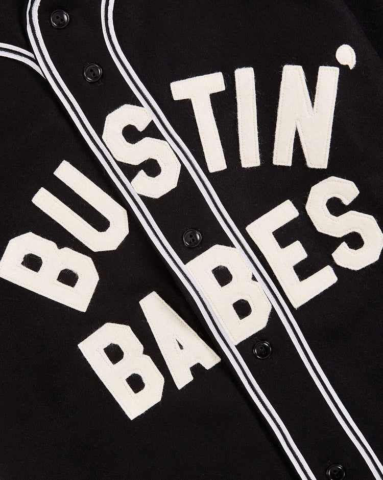 The Ebbets Field Babe Ruth Bustin' Babes Authentic Wool Baseball Jersey features a black design with white trim and bold “BUSTIN’ BABES” lettering, inspired by Babe Ruth’s legendary team.