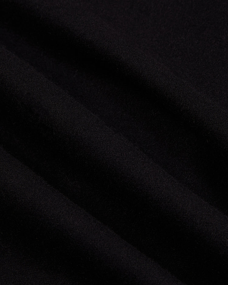 Close-up of soft black wool fabric with gentle folds, from the Ebbets Field Babe Ruth Bustin' Babes Authentic Wool Baseball Jersey, capturing subtle shadows and highlights reminiscent of classic baseball style.