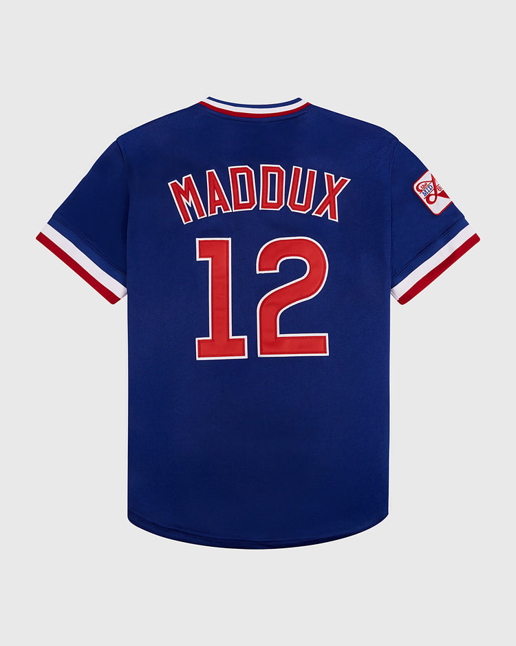The Ebbets Field Greg Maddux Peoria Chiefs V-Neck Jersey is blue with red and white trim, featuring 