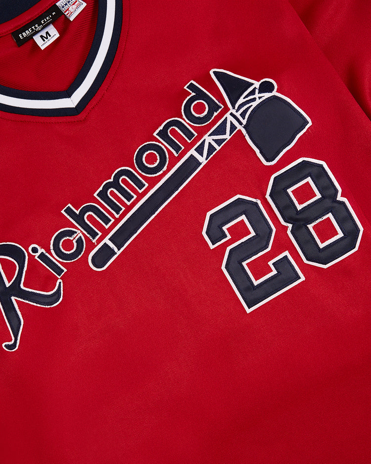 The Ebbets Field John Smoltz Richmond Braves V-Neck Jersey features red fabric, white and navy lettering above a tomahawk, bold white/navy number 28 on the lower right, and a size M tag—a classic minor league collectible.