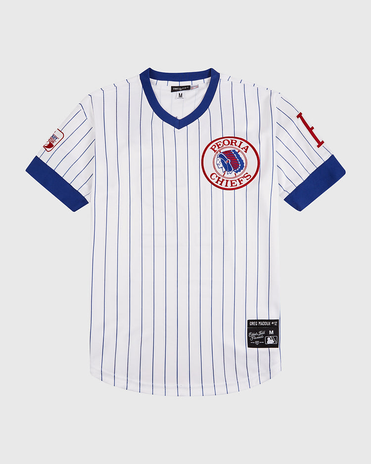 The Ebbets Field Greg Maddux Peoria Chiefs V-Neck Jersey is a white minor league jersey with blue pinstripes, blue cuffs and collar, a red Chiefs chest logo, and a red 