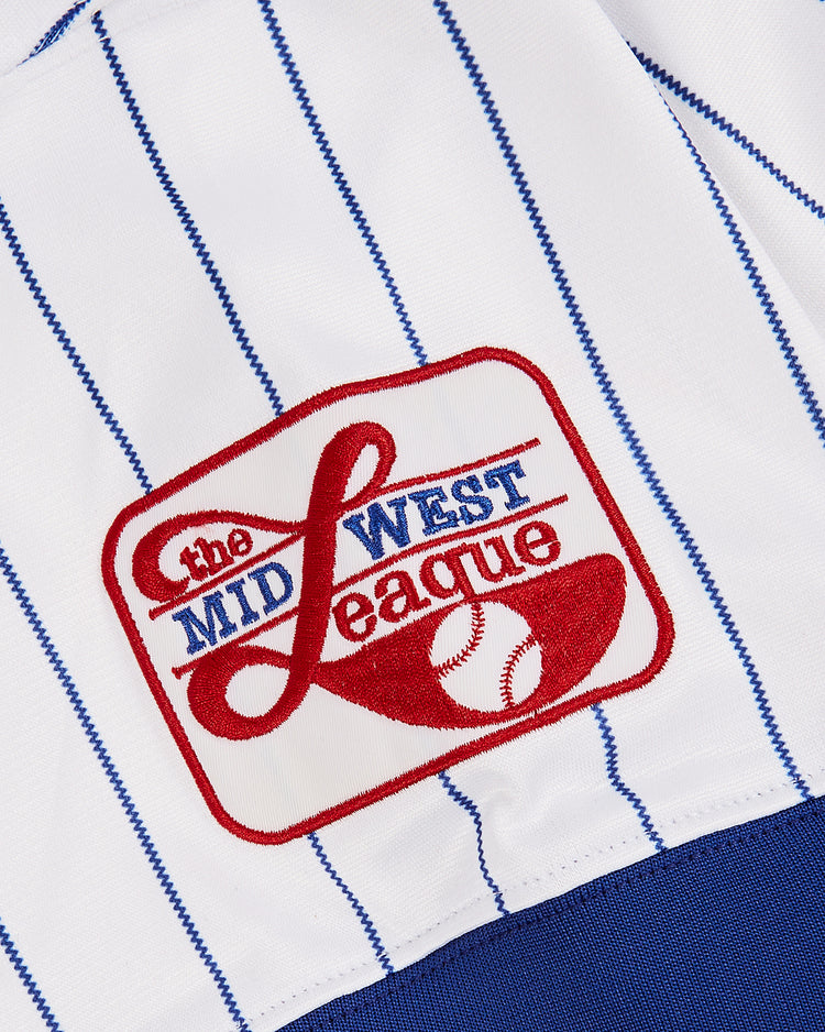 Close-up of the Ebbets Field Greg Maddux Peoria Chiefs V-Neck Jersey, a white minor league baseball jersey with blue pinstripes and a Midwest League red, white, and blue embroidered patch featuring a stylized baseball.