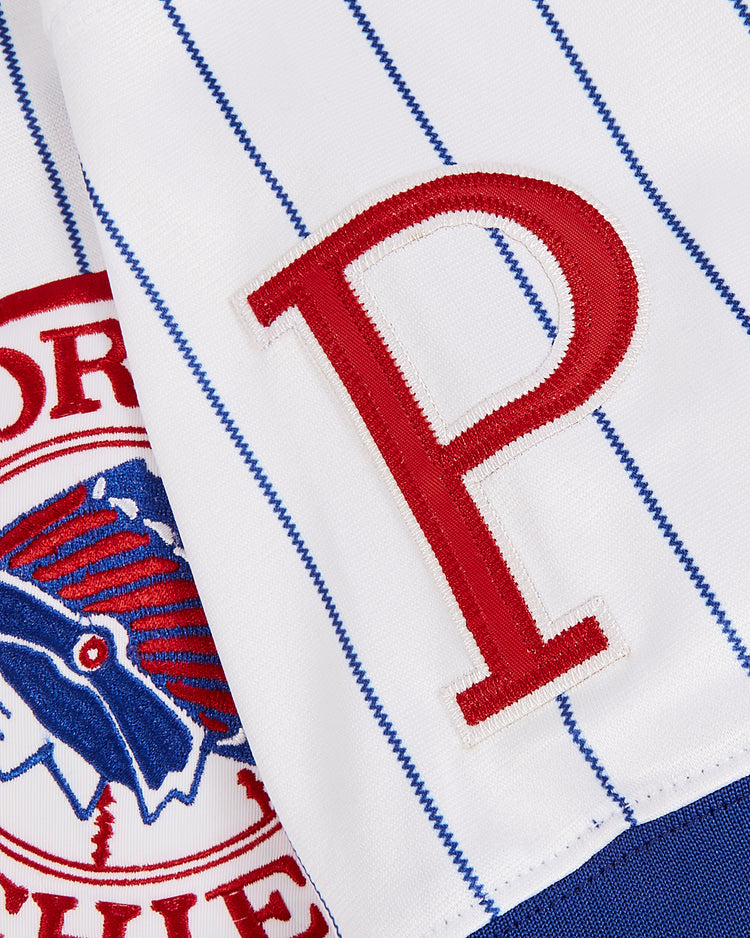 Close-up of the white pinstriped fabric on the Ebbets Field Greg Maddux Peoria Chiefs V-Neck Jersey, featuring a bold red 