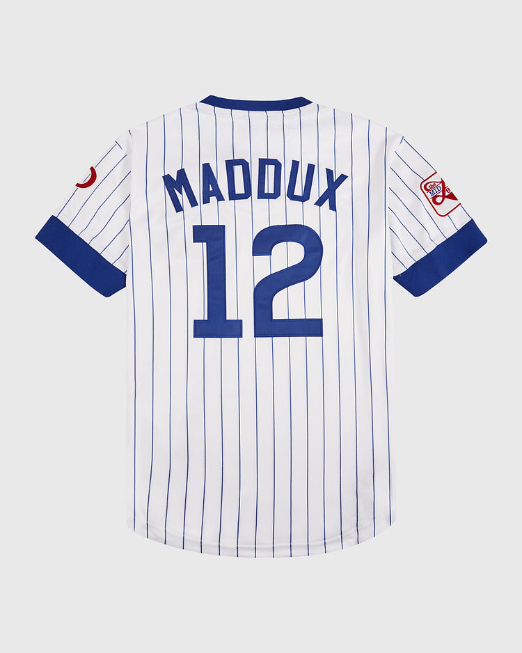 The Ebbets Field Greg Maddux Peoria Chiefs V-Neck Jersey features white fabric with blue pinstripes, 