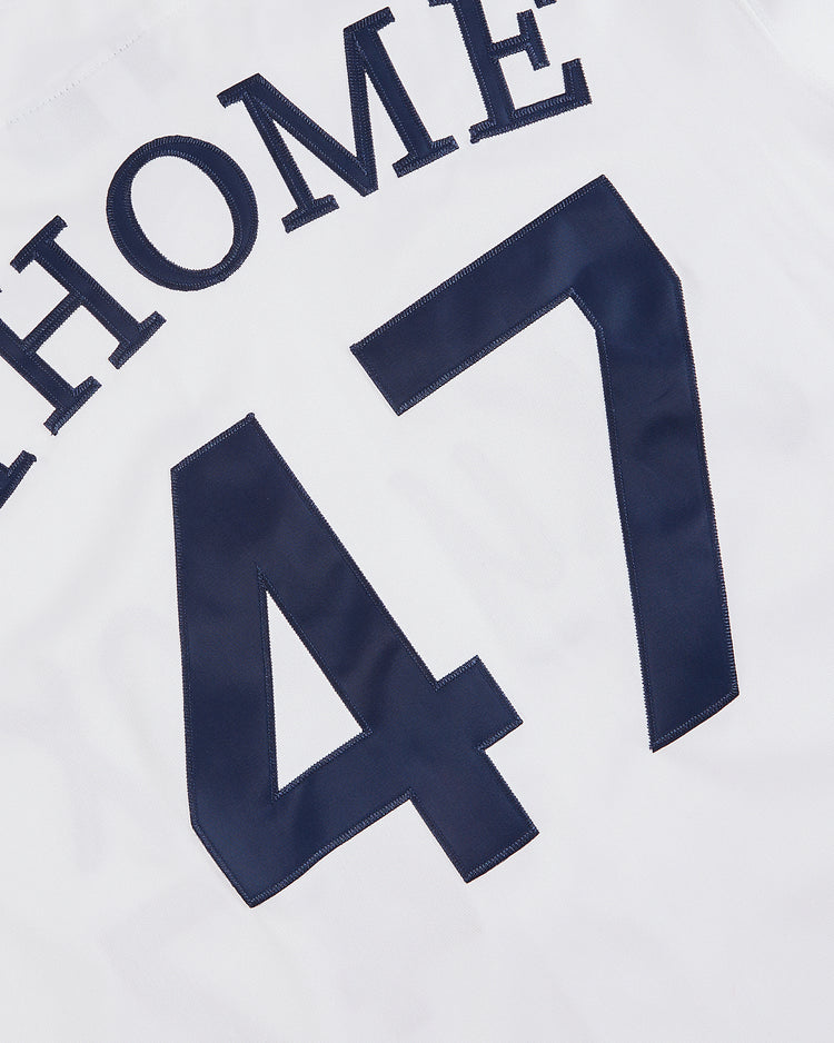 The Ebbets Field Jim Thome Colorado Springs Sky Fox Button Up Jersey is a white minor league style featuring the dark blue number 47 and partial 