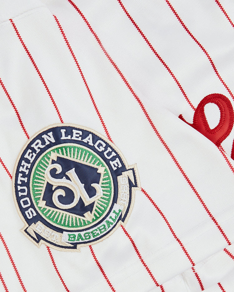 Close-up of the EFF Trevor Hoffman Chattanooga Lookouts Button Up Jersey, a white jersey with red pinstripes, embroidered Southern League Baseball patch, and part of a red cursive letter—classic Lookouts style.