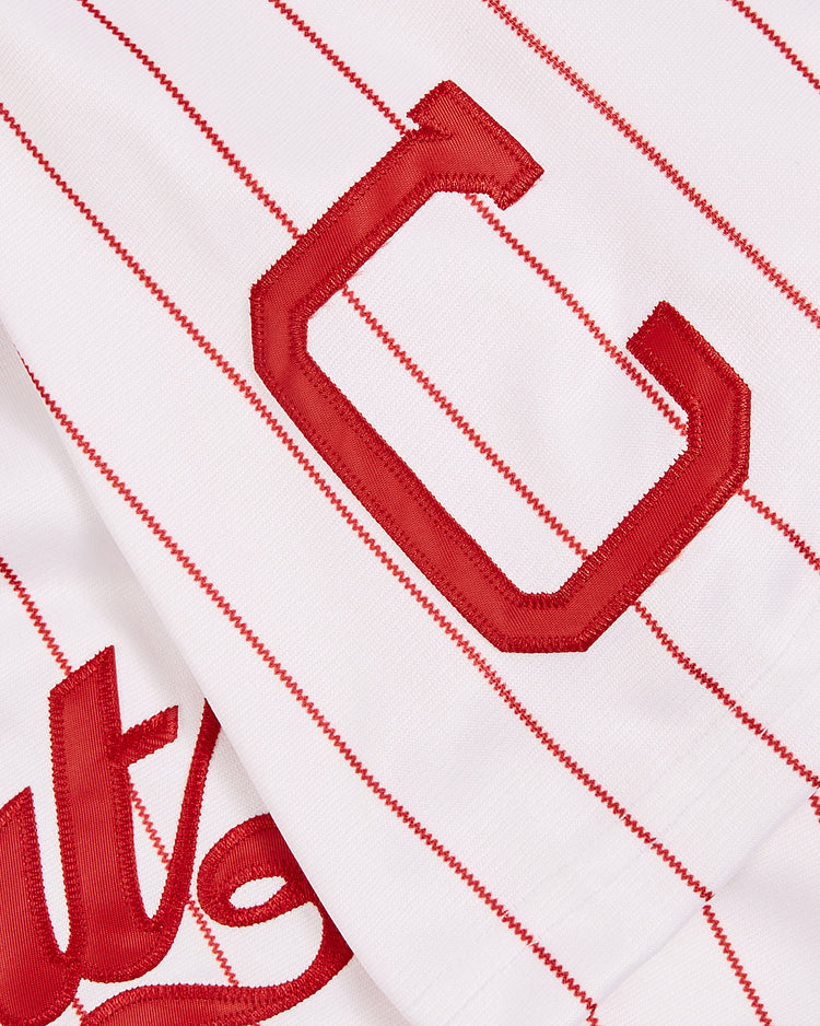 A close-up of the Chattanooga Lookouts EFF MiLB Button Down Jersey by EFF, showing thin red stripes, a bold red C patch, and part of the red script logo on a white background.