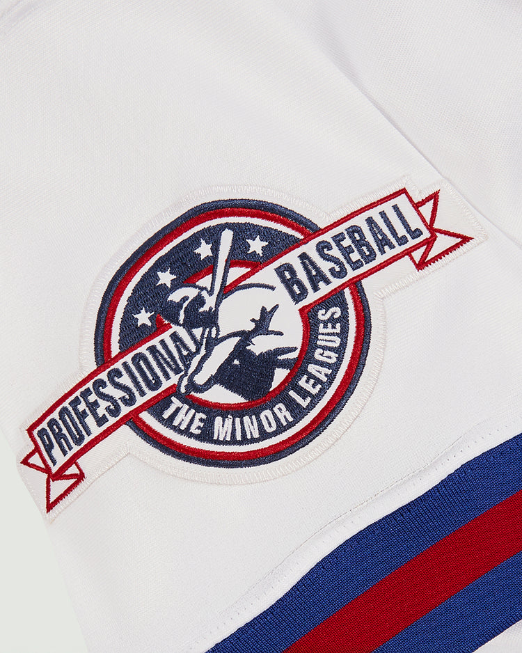A patch on a white fabric features a baseball player silhouette, stars, and stripes, with 