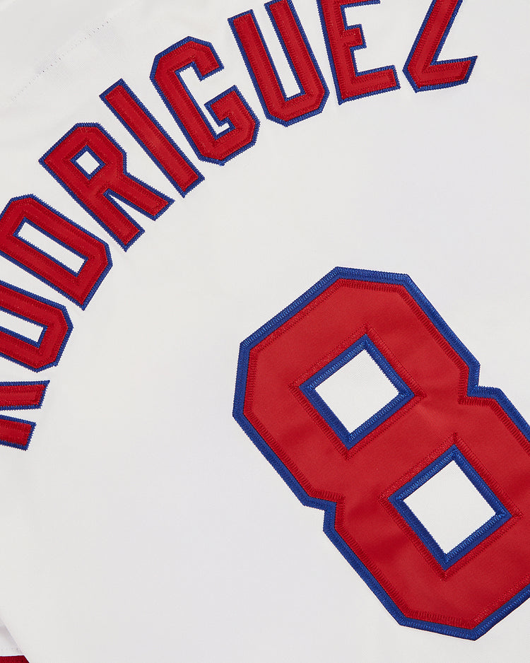 A close-up of the Pudge Rodriguez Tulsa Drillers Button Up Jersey by Ebbets Field features his name and number 8, with red and blue trim—a tribute to the Texas Rangers legend.