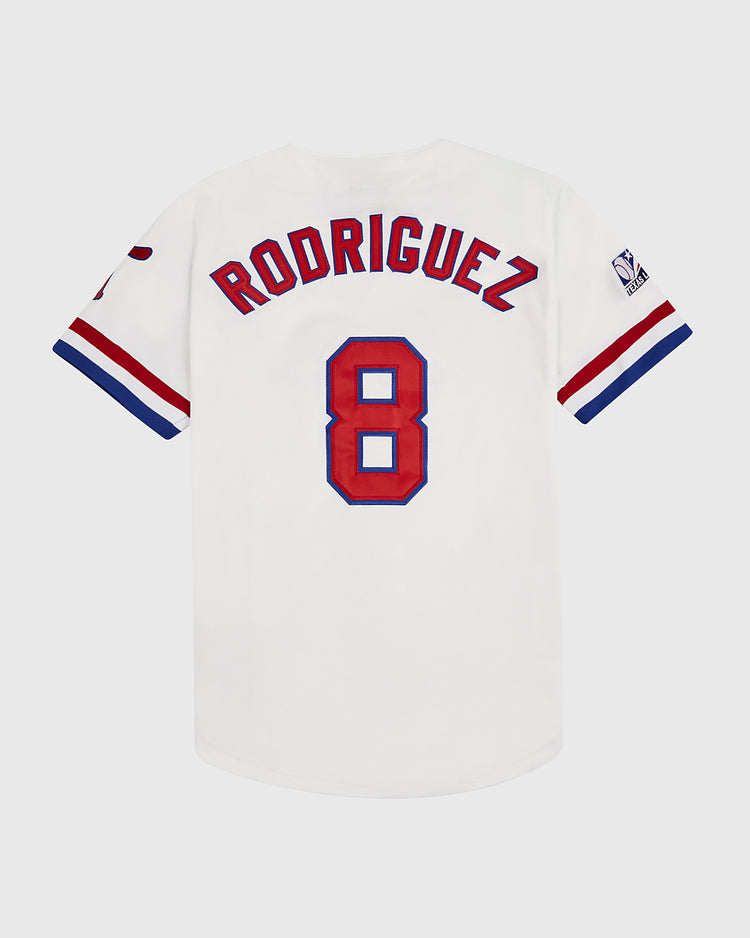 The Ebbets Field Pudge Rodriguez Tulsa Drillers Button Up Jersey is a white jersey with red and blue accents, featuring RODRIGUEZ and number 8 on the back—a tribute to the legendary catcher.