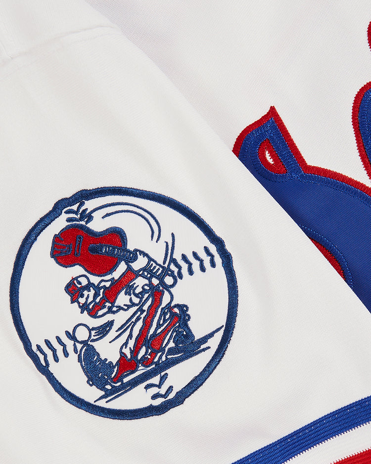 Close-up of the EFF Trevor Hoffman Nashville Sounds Button Up Jersey featuring a circular patch with a catcher and batter, outlined in blue stitching, next to part of a large red and blue letter.