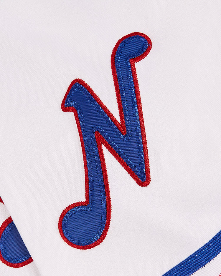 A close-up of a white Nashville Sounds EFF MiLB Button Down Jersey by EFF, featuring a large blue letter N outlined in red stitching—an essential piece for any vintage Minor League collection. The detail highlights the jersey’s classic sports style.