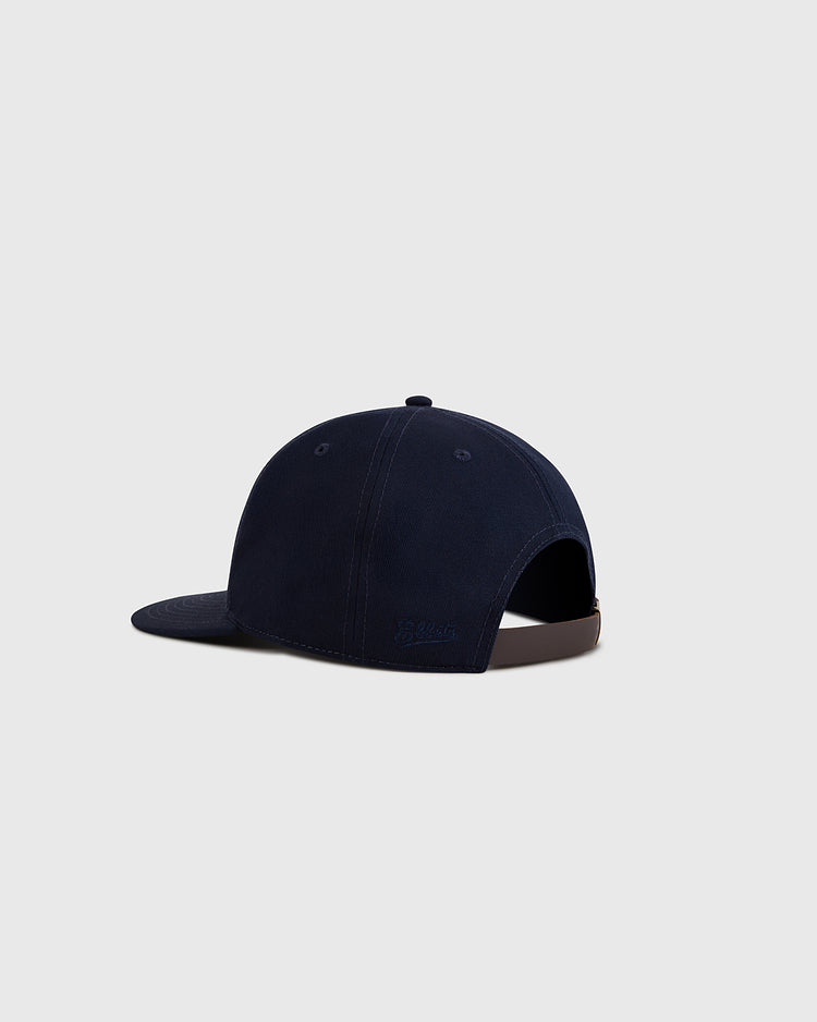 The Ebbets Field Navy Cotton Twill Ballcap is shown from the back on a light gray background, featuring cotton twill fabric and an adjustable strap with a brown buckle.