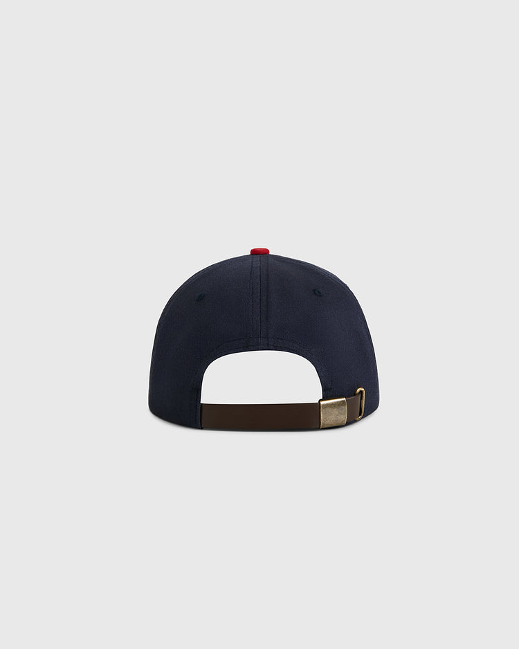 The Ebbets Field USA National Team Cotton Twill Ballcap is shown from the back, highlighting its brown adjustable strap with brass buckle and a red top button, set against a plain light gray background.