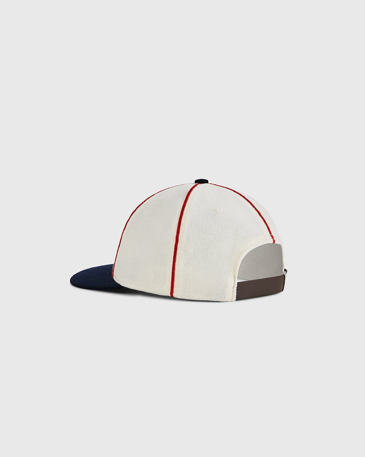 The Ebbets Field USA National Team 1936 Authentic Wool Ballcap features white wool, red vertical stitching, a dark navy brim, and an adjustable brown strap—designed in classic Olympic baseball style. Shown against a plain light background.