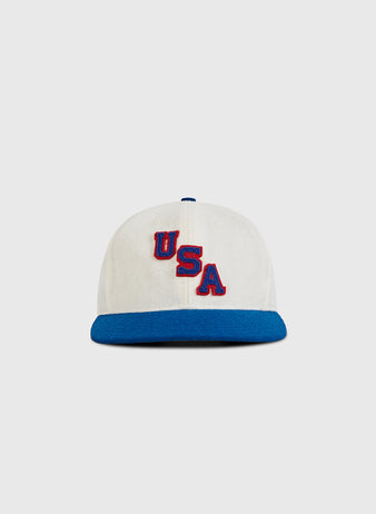 The Ebbets Field USA Miracle On Ice 1960 Wool Ballcap is a vintage-style white hat with a blue brim and red, blue-outlined 