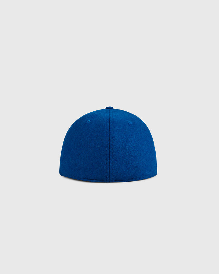 The Ebbets Field USA Miracle On Ice 1960 Wool Ballcap is displayed from the back against a light gray background, showcasing its classic blue fitted design inspired by vintage hockey hats.
