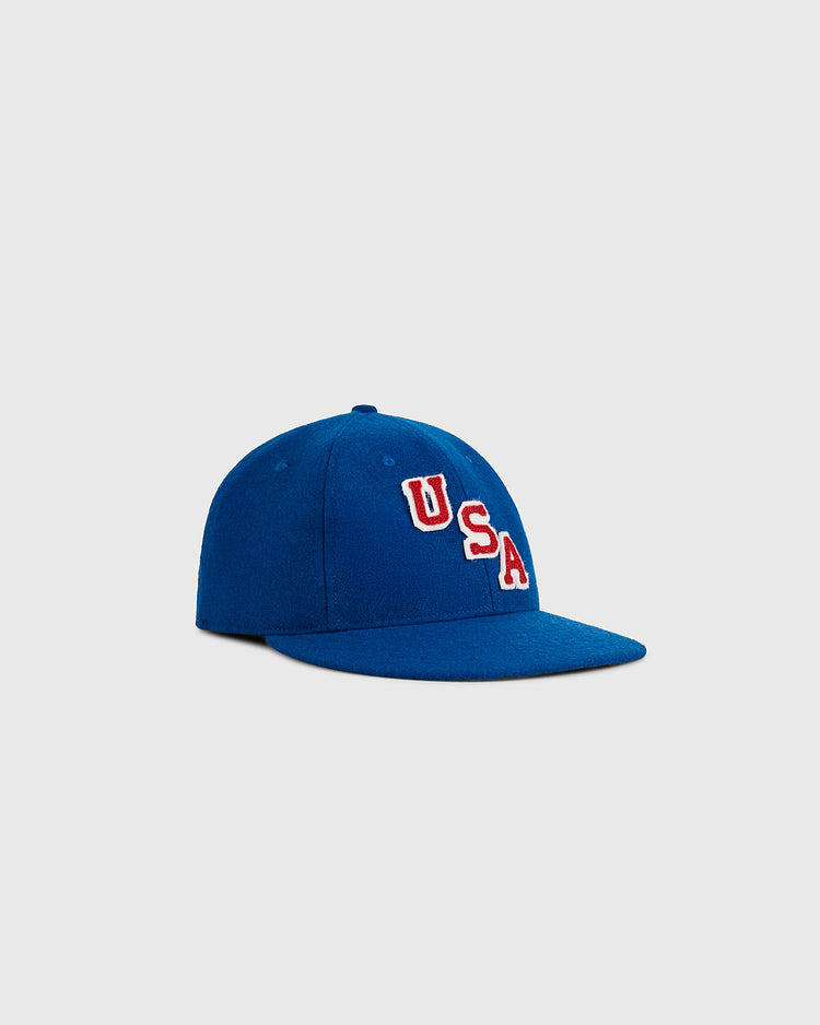 The Ebbets Field USA Miracle On Ice 1960 Wool Ballcap is a blue cap featuring 