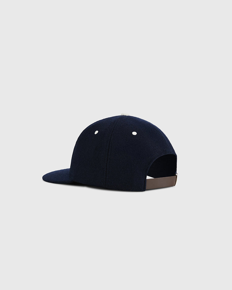 The Ebbets Field USA Stars and Bars Shield Wool Ballcap is shown from the back and side, featuring white eyelets, an adjustable rear strap, and a subtle stars and stripes shield patch—expertly made in the USA on a light gray background.
