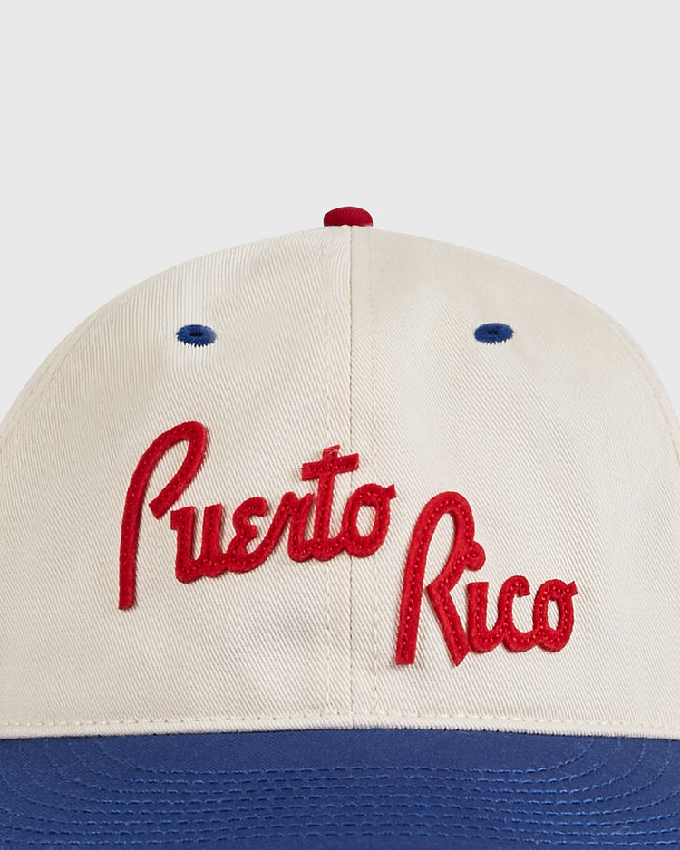 A close-up of the Ebbets Field Puerto Rico 1958 National Team Cotton Twill Ballcap, featuring beige fabric, red embroidered 