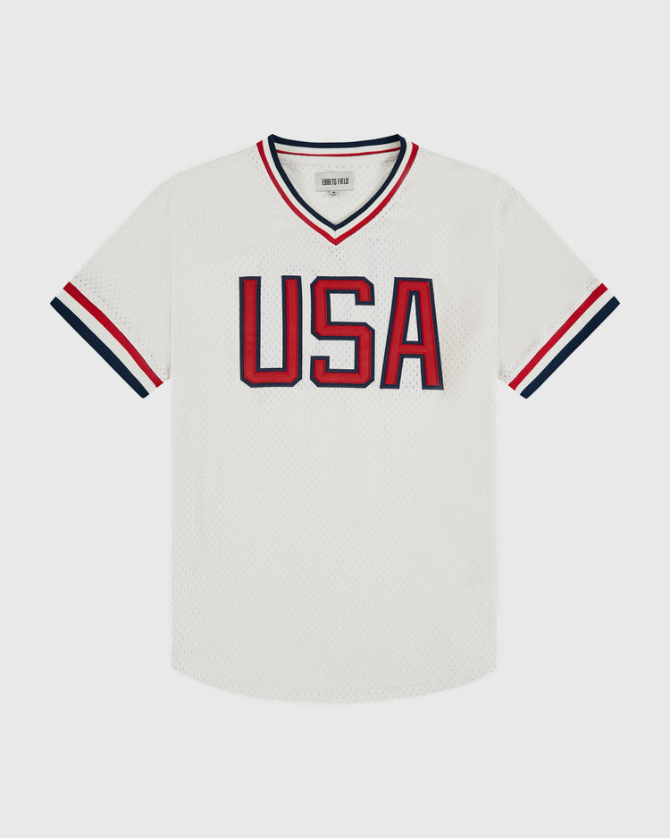 The Ebbets Field USA National Team Mesh V-Neck Jersey is a white mesh baseball jersey with bold red and blue 
