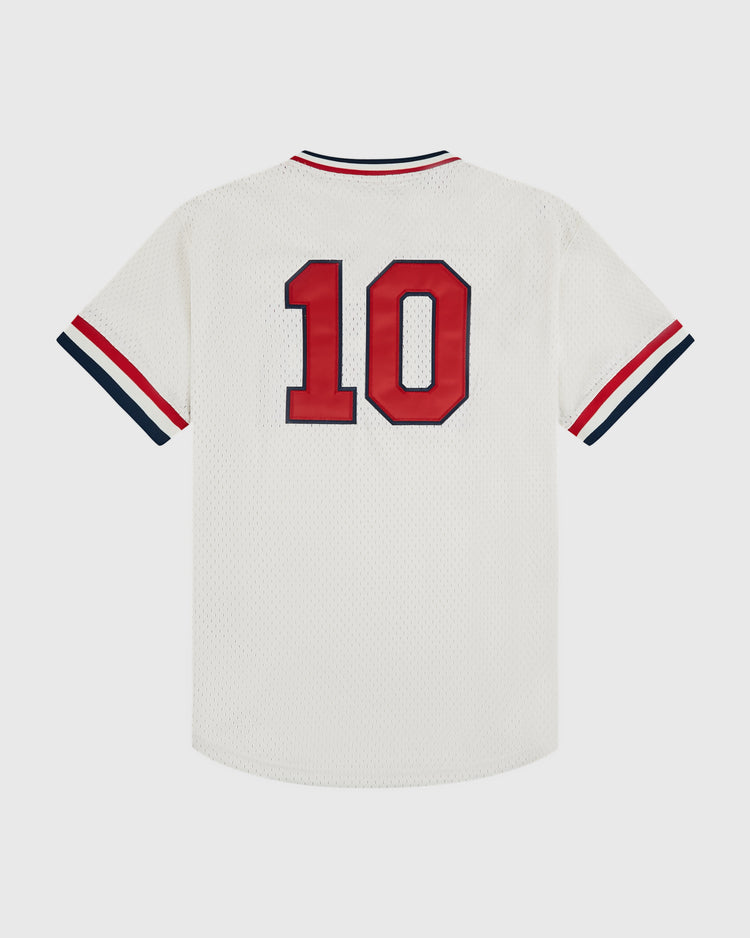 The Ebbets Field USA National Team Mesh V-Neck Jersey is a vintage-style white jersey with red and navy trim, featuring a bold red number 10 on the back, inspired by the classic 1956 USA Olympics design.