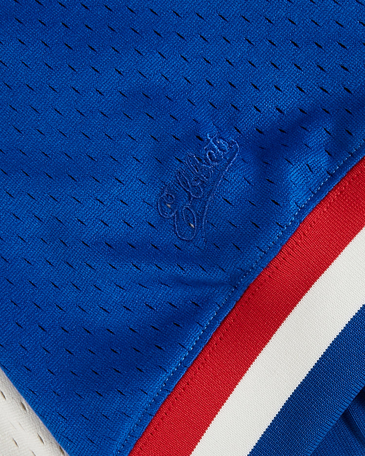 Close-up of blue perforated mesh on the Ebbets Field Puerto Rico 1976 National Team Mesh V-Neck Jersey, featuring embroidered script and red, white, and blue striped trim for a vintage look.