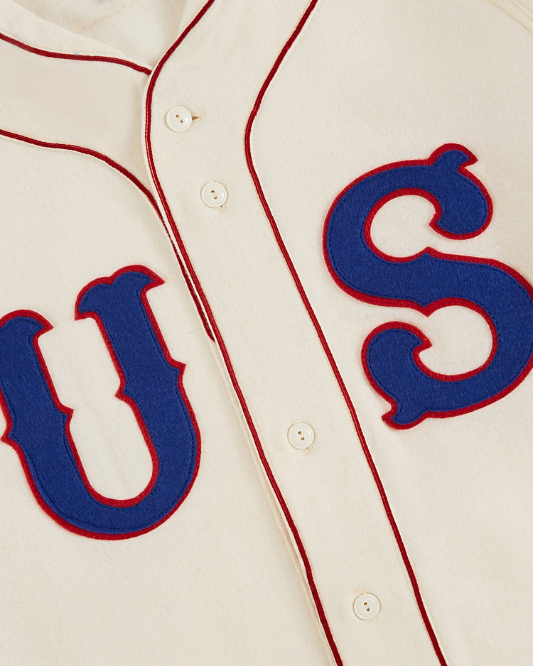 Close-up of the Ebbets Field USA National Team 1936 Authentic Wool Baseball Jersey: cream wool, red piping, blue “U S” outlined in red, and four white front buttons, capturing classic 1936 baseball style.