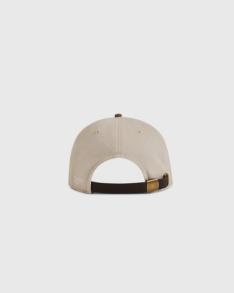 The Brooklyn Royal Giants 1925 Cotton Twill Suede Ballcap by Ebbets Field is shown from the back, featuring beige cotton, a dark brown adjustable strap with brass buckle, and a plain light gray background inspired by classic Negro leagues style.