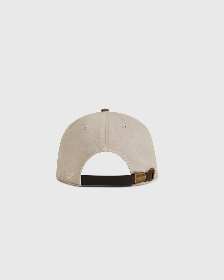The Ebbets Field Kansas City Monarchs 1945 Cotton Twill Suede Ballcap in beige is shown from the back, featuring a dark adjustable strap with a brass buckle and stitched eyelets for ventilation.