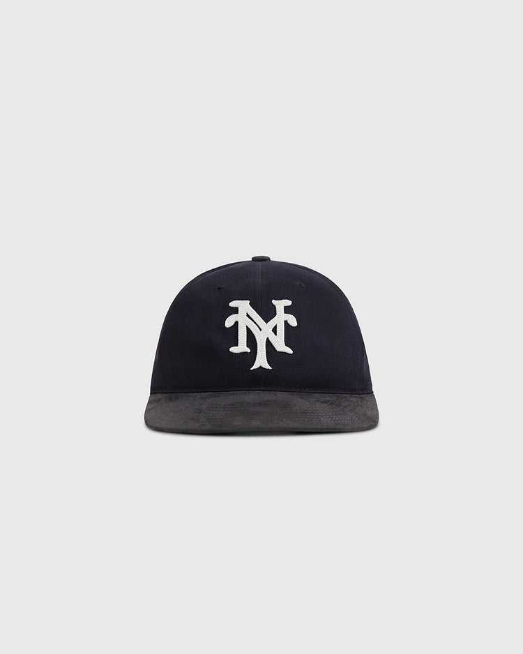 The Ebbets Field New York Cubans 1948 Cotton Twill Suede Ballcap features a navy crown, gray brim, and white interlocking NY logo, inspired by the Negro League team. Shown on a plain light gray background.