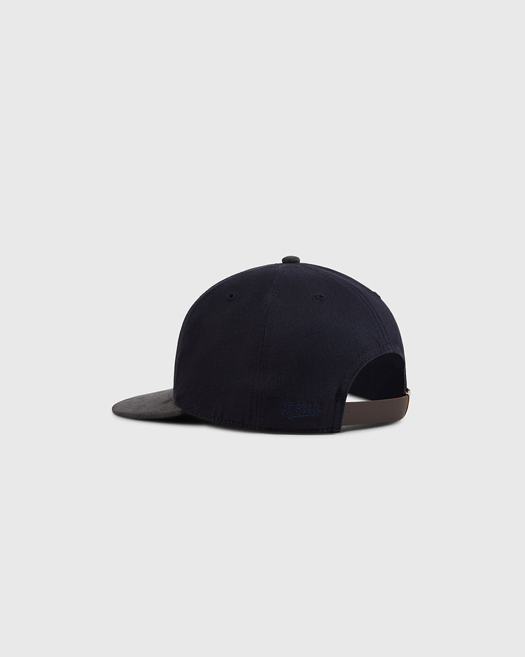 The Ebbets Field New York Cubans 1948 Cotton Twill Suede Ballcap in navy is shown from the back, featuring a curved brim and adjustable strap. This vintage-inspired cap nods to Negro League baseball, set against a plain light gray background.