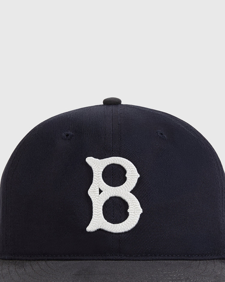 A close-up of the Ebbets Field Brooklyn Royal Giants 1925 Cotton Twill Suede Ballcap, featuring a white stylized 