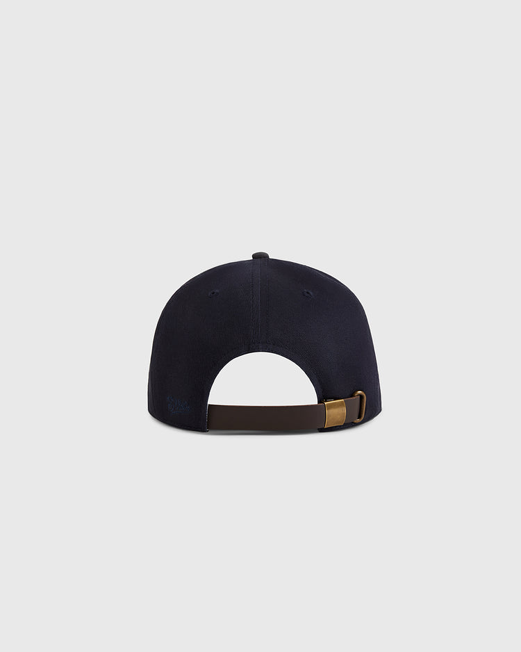 The Brooklyn Royal Giants 1925 Cotton Twill Suede Ballcap by Ebbets Field, shown from the back, features a navy blue design with a brown adjustable strap and brass buckle against a plain light gray background.