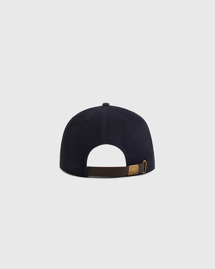 The Ebbets Field Kansas City Monarchs 1945 Cotton Twill Suede Ballcap is shown from the back, highlighting its adjustable brown strap with a brass buckle against a plain light gray background.