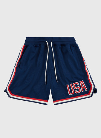 The Ebbets Field USA National Team Mesh Shorts feature navy blue breathable knit mesh, red, white, and blue striped trim, white drawstrings, and bold red and white “USA” lettering on the left leg, displayed on a plain light background.
