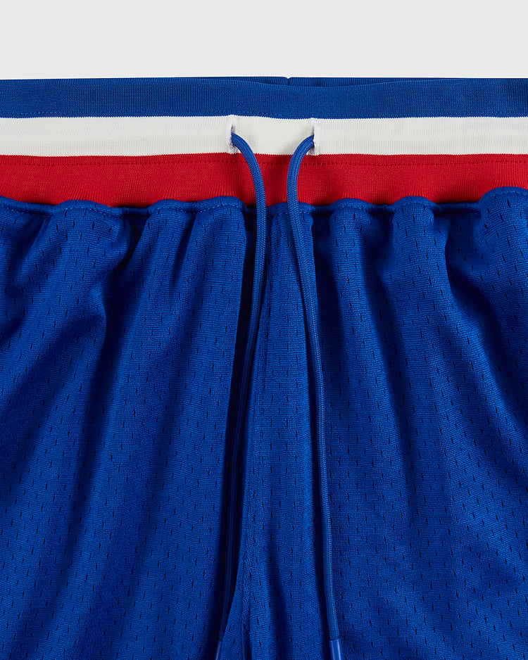 Close-up of Santurce Cangrejeros Mesh Shorts by Ebbets Field, featuring blue mesh, a drawstring waist, and a tricolor waistband inspired by Puerto Rican baseball shorts and Roberto Clemente.