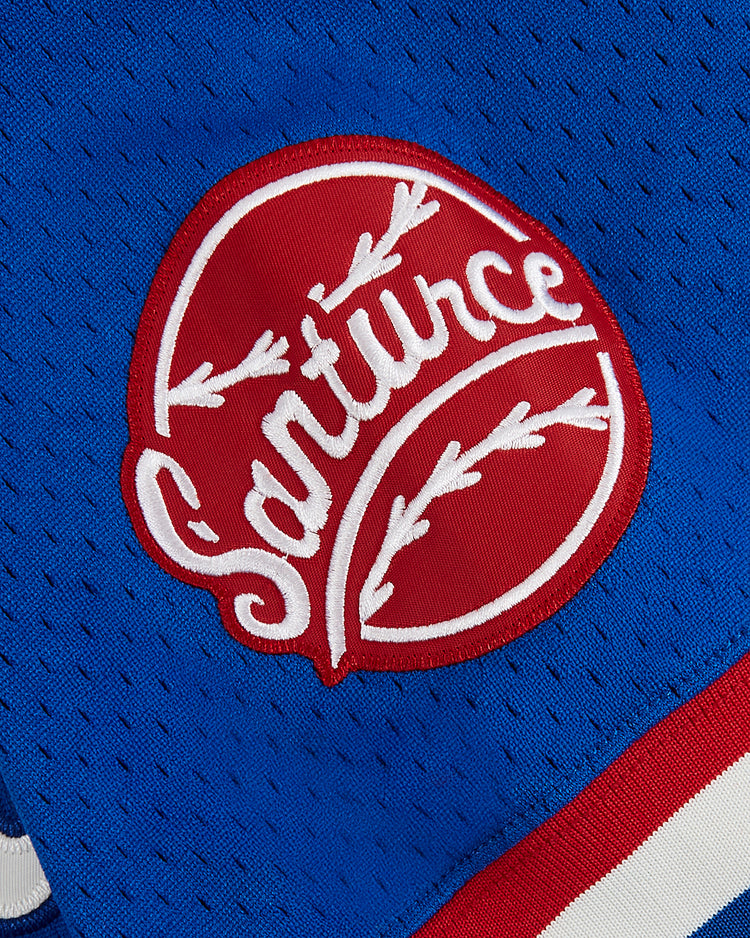 A close-up of the Ebbets Field Santurce Cangrejeros Mesh V-Neck Jersey, featuring a blue design with a red and white 