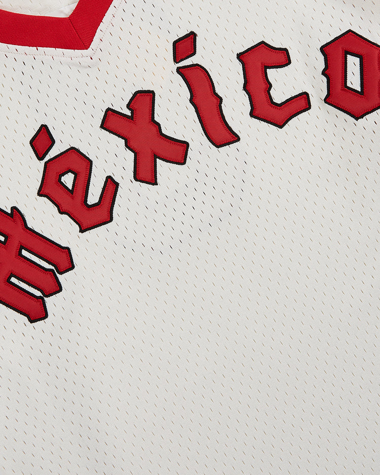 Close-up of the Ebbets Field Diablos Rojos de Mexico V-Neck Mesh Jersey, featuring white mesh, red trim, and bold red “México” lettering for a classic Liga Mexicana de Beisbol look.
