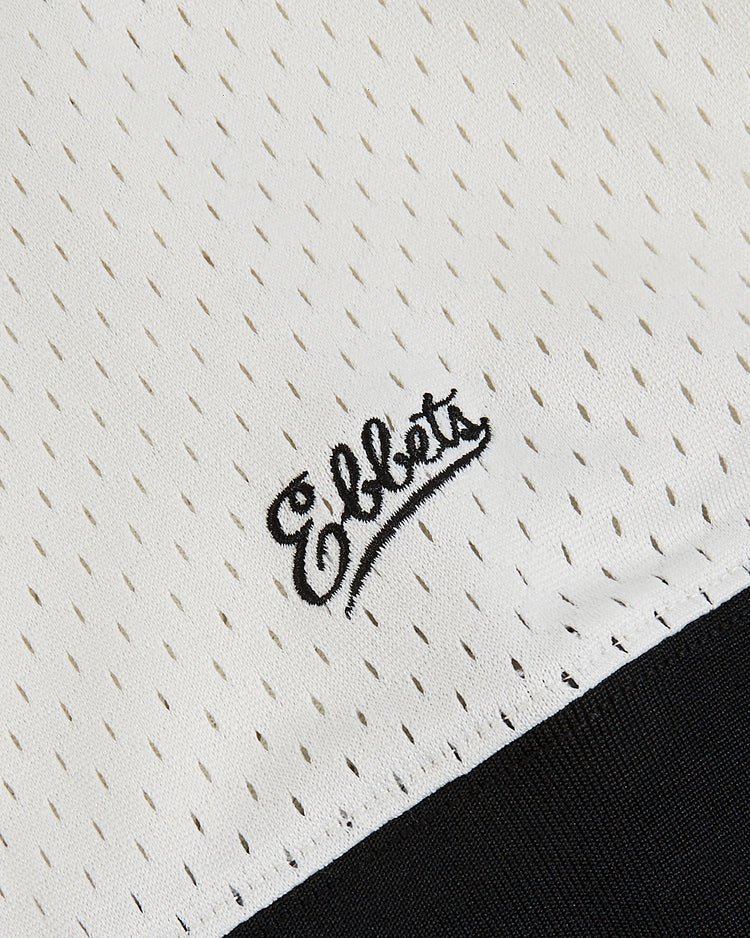 Close-up of the Satchel Paige All-Stars Mesh V-Neck Jersey by Ebbets Field, showing white mesh fabric with small perforations, 