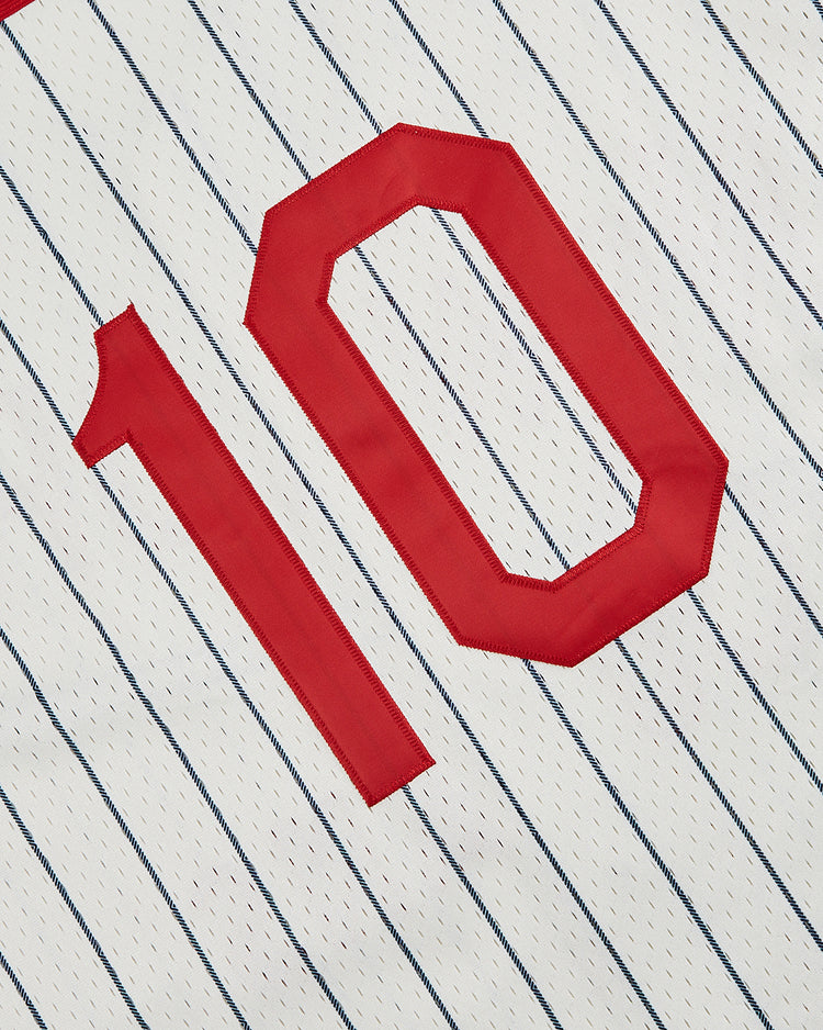 A close-up of the Ebbets Field New York Cubans Mesh Button-Up Jersey, featuring white fabric with thin blue pinstripes and a bold red number 10, honoring the legendary Negro League team.