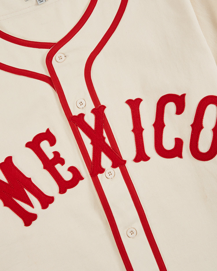 Close-up of the Ebbets Field Diablos Rojos del Mexico Cotton Twill Baseball Jersey, featuring cream-colored cotton twill, red trim, and 