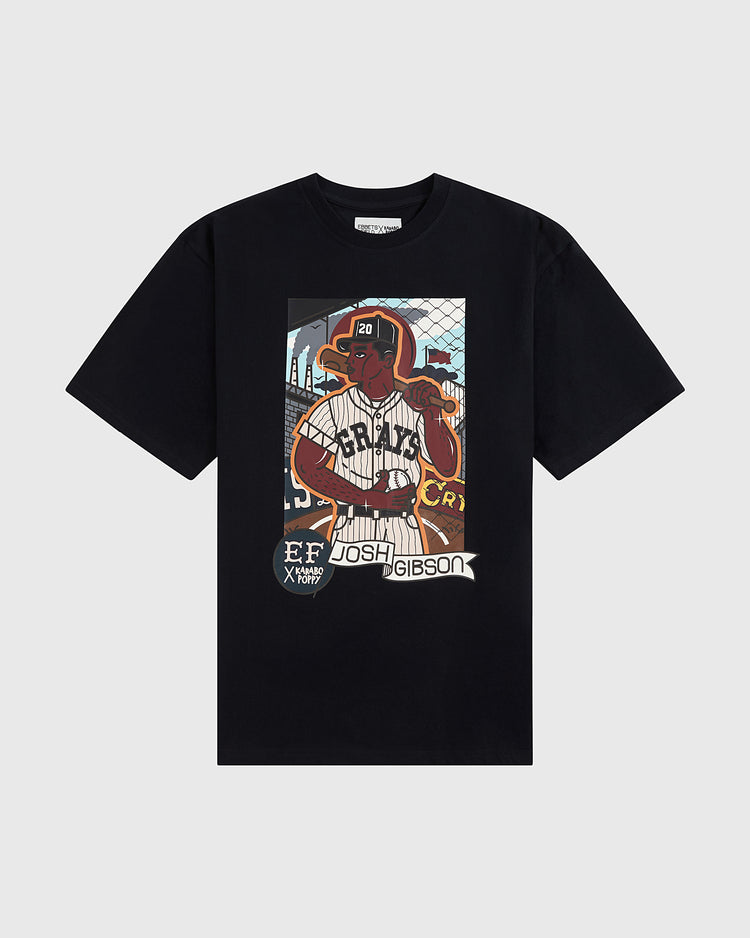 The Karabo Poppy x Ebbets Field Josh Gibson Short Sleeve Graphic Tee by Ebbets Field features a vibrant baseball player graphic and honors the Negro Leagues, with “Josh Gibson” and “EF X KROST” text over a field-inspired background.