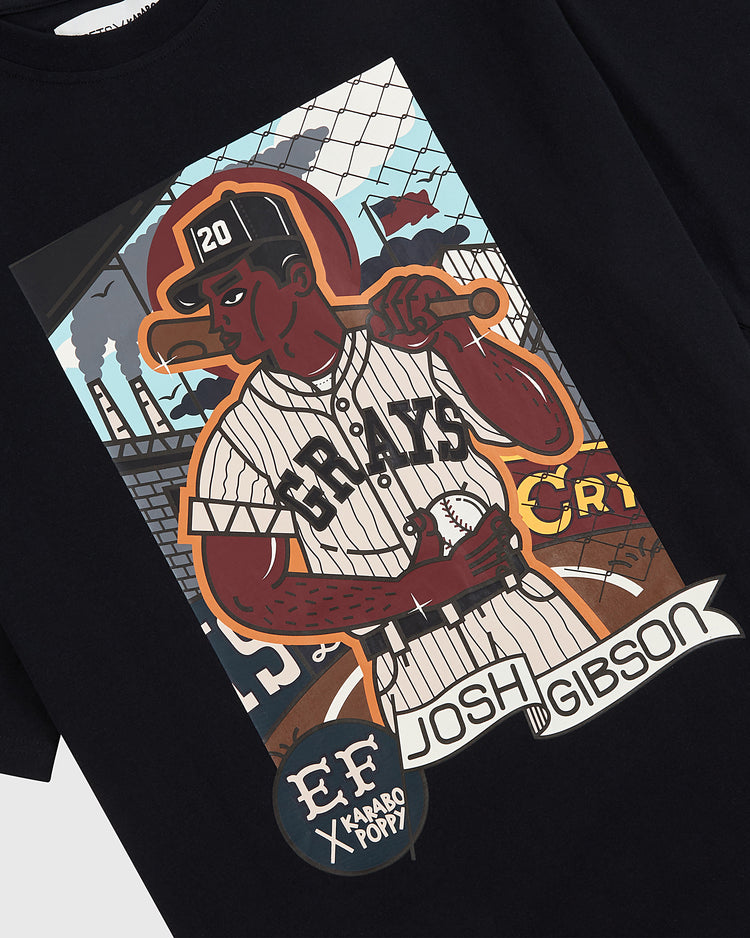 The Karabo Poppy x Ebbets Field Josh Gibson Short Sleeve Graphic Tee by Ebbets Field features a graphic of Negro Leagues legend Josh Gibson in a striped uniform with a bat and stadium background, with his name at the bottom.