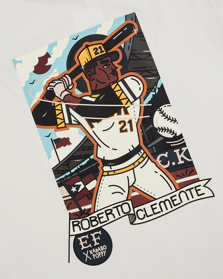 Celebrate Black History Month with the Ebbets Field Karabo Poppy x Ebbets Field Roberto Clemente Short Sleeve Graphic Tee, featuring a stylized illustration of Clemente at bat and bold graphics—perfect tribute to an MLB legend.