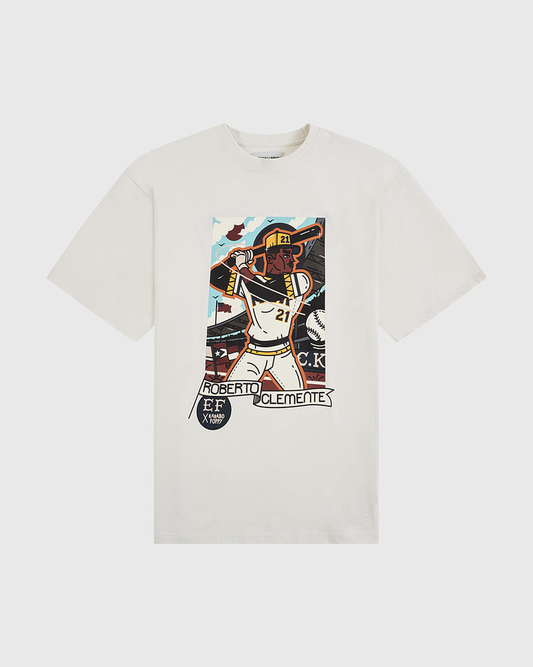 The Ebbets Field Karabo Poppy x Roberto Clemente Short Sleeve Graphic Tee features a vibrant mid-swing illustration of Clemente in #21—his name and bat below—making it a bold tribute, ideal for Black History Month.