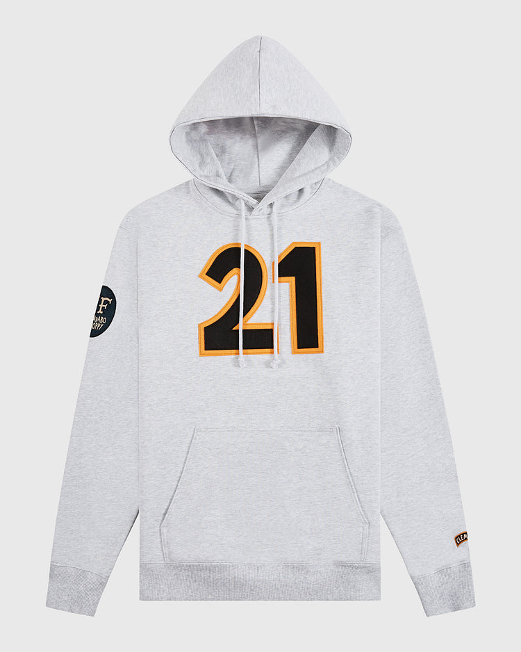 Celebrate Black History Month in the Ebbets Field Karabo Poppy x Roberto Clemente hoodie—light gray, bold black and yellow #21 front, sleeve patch details, and a cozy kangaroo pocket.